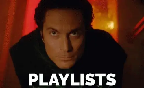 Animated GIF of a man looking up at the camera with the word PLAYLISTS in large white letters