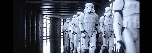 Black and white GIF of a row of stormtroopers marching down a corridor