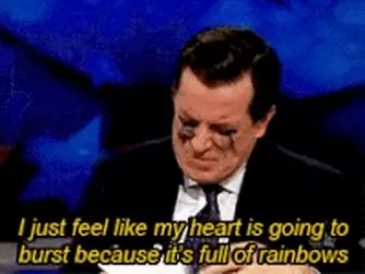 GIF of a man in a suit with the caption 'I just feel like my heart is going to burst because it's full of rainbows'