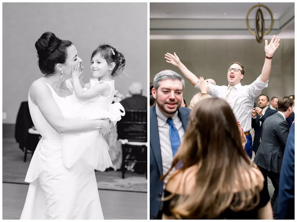 Black and white bride holding a flower girl, beside a guest dancing with arms raised