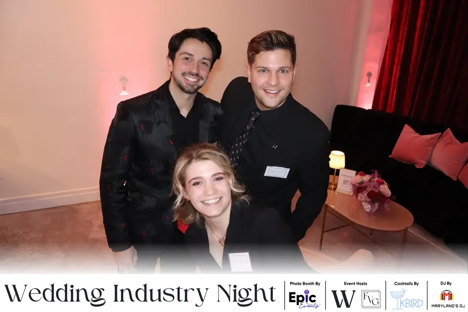 Two men and a woman smiling for a photo booth picture at Wedding Industry Night