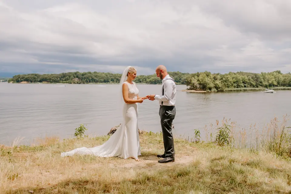 Image of a bridge and groom in front of a body of water